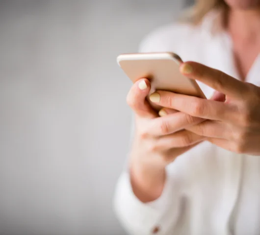 a person holding a white mug
