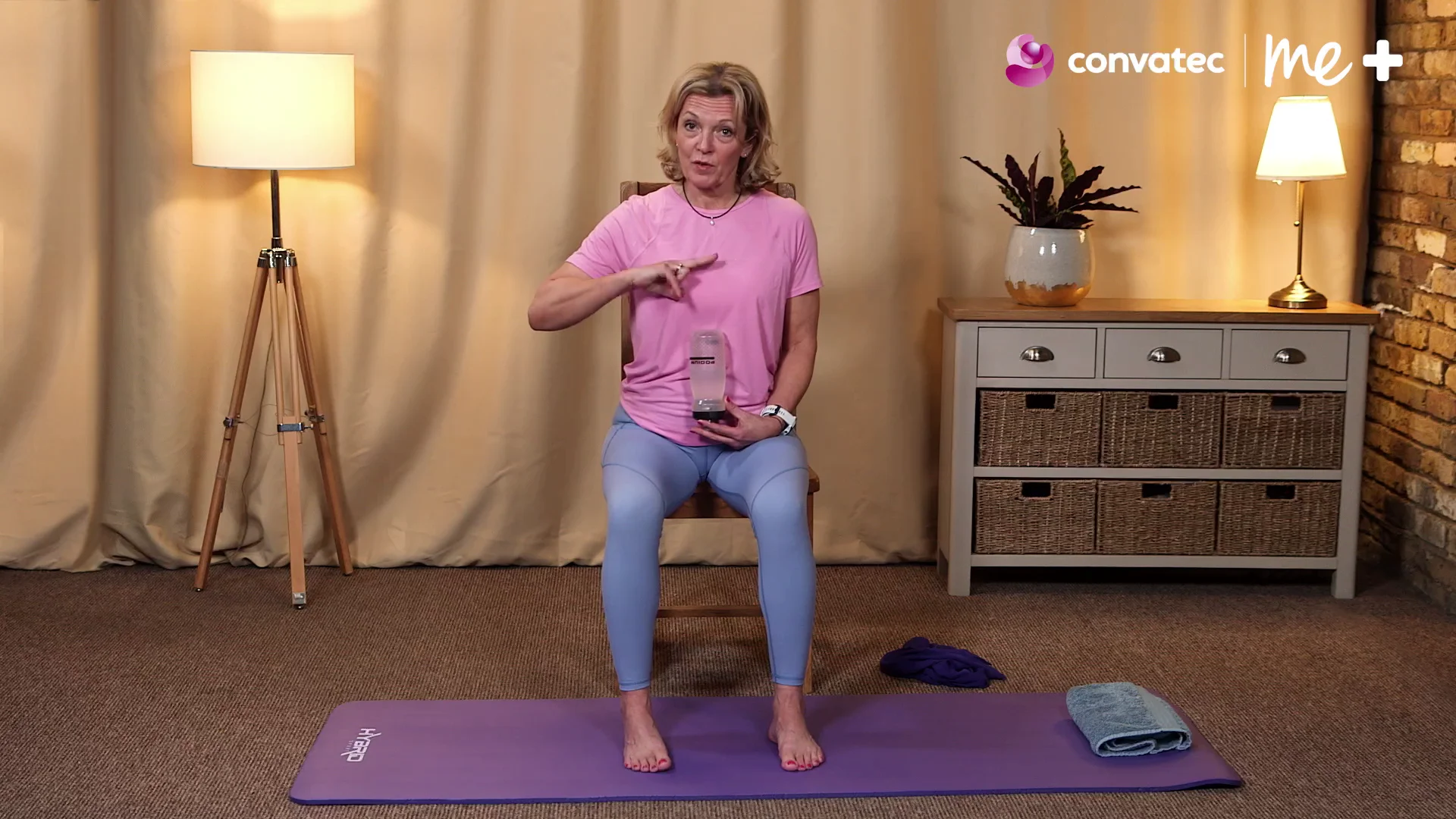 a person sitting on a purple mat